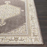 Close-up of the Clyo Carpet, a hand-knotted wool rug in brown, off-white, and gray on dark wood flooring. Front