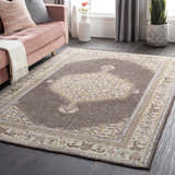 Brown Clyo Carpet, a hand-knotted wool rug with traditional design in a styled living room. Roomscene-Rectangle