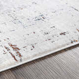 Close-up of Concordia Faux Silk Rug showing off-white, gray, and burnt orange abstract pattern and soft texture. Texture