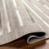 Close-up of the Cantu Premium Viscose&Leather Area Rug, showcasing its geometric pattern and light beige, gray tones. Fold