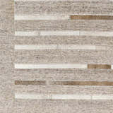 Close-up of the Cantu Premium Viscose&Leather Area Rug. Features a geometric design with beige, gray, and leather stripes. Swatch