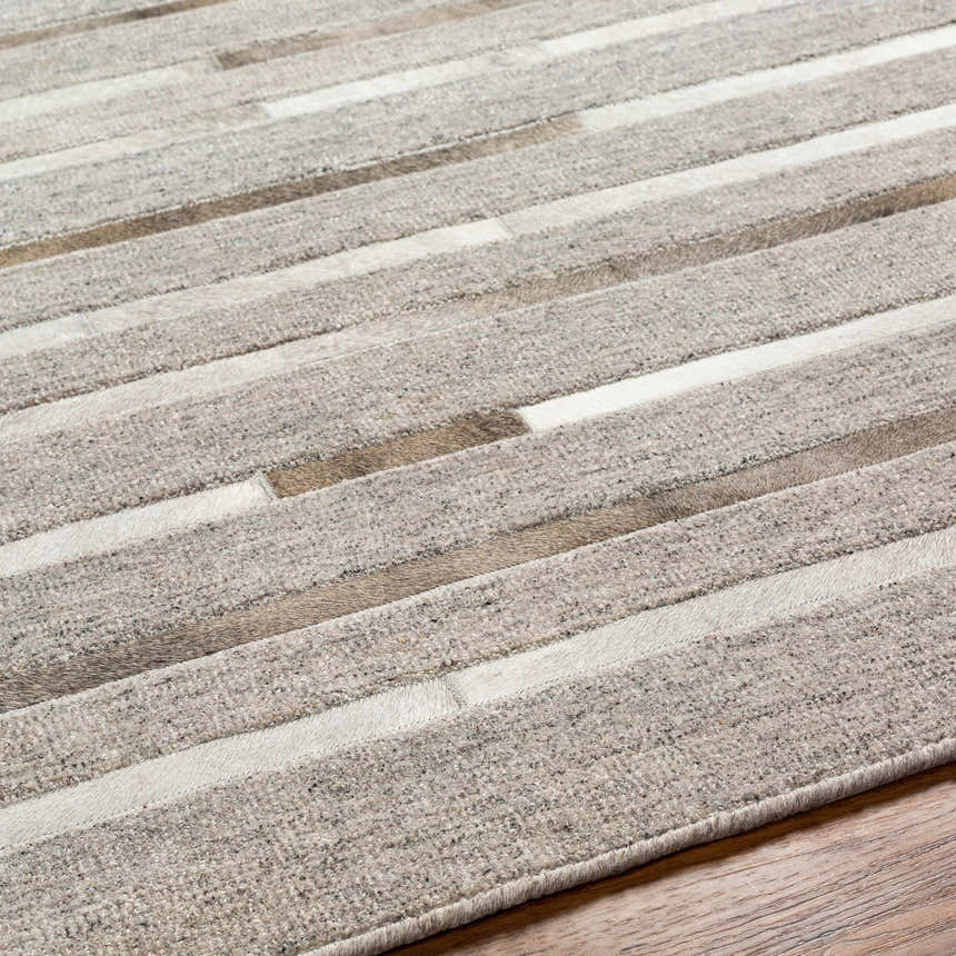 Close up of Cantu Premium Viscose&Leather Area Rug featuring a geometric pattern in light beige, light gray and medium gray. Texture