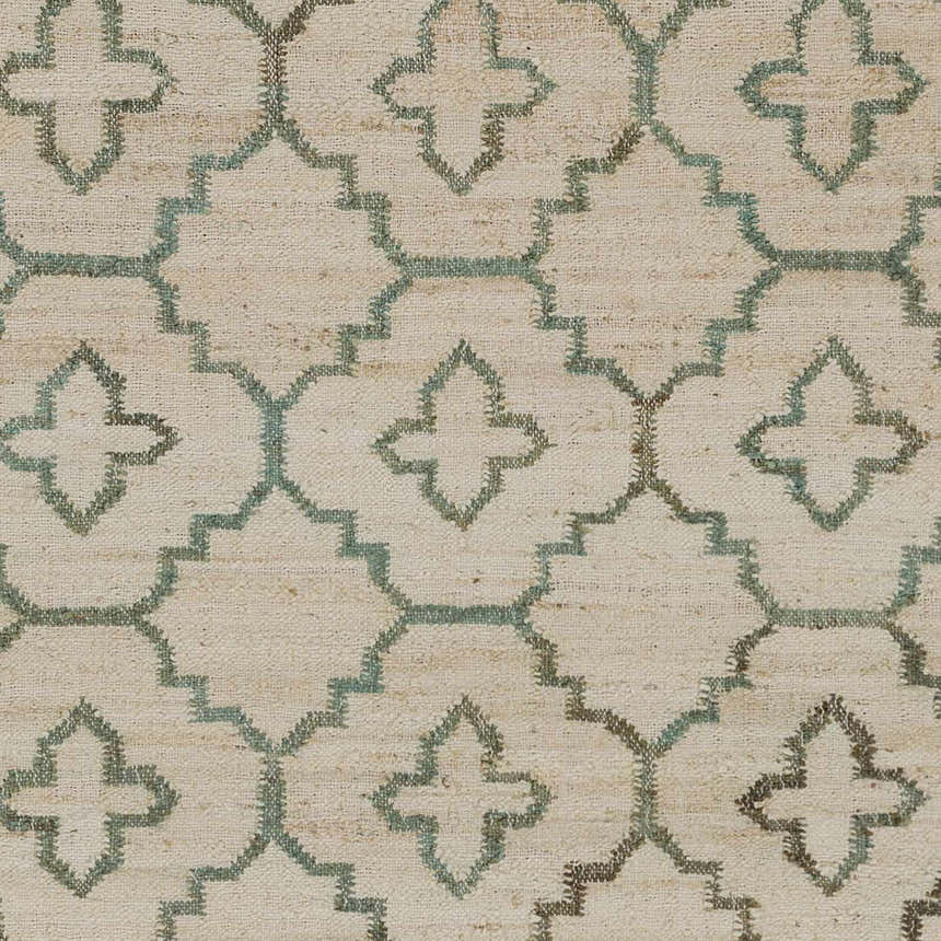 Close-up of Coffeyville rug. Cream jute carpet with a sage and ivory geometric pattern. Handcrafted, fringed texture. Swatch