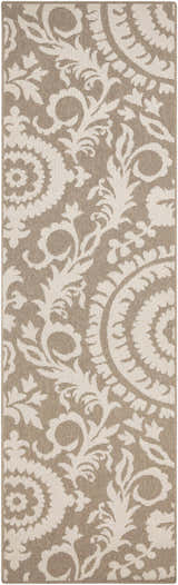Close-up of the Collegeport Area Rug. Light beige floral pattern on a light brown olefin rug. Machine woven texture. Design-Runner-2379