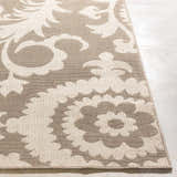 Close-up of the Collegeport Area Rug. Light beige floral pattern on a light brown, machine-woven olefin rug. Front