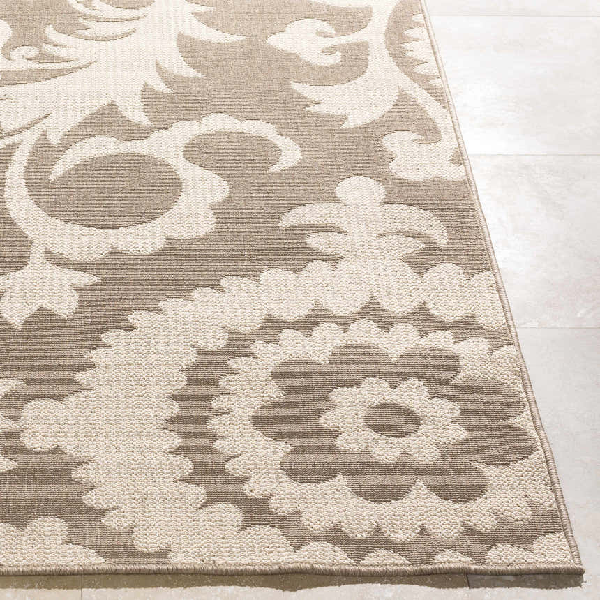 Close-up of the Collegeport Area Rug. Light beige floral pattern on a light brown, machine-woven olefin rug. Front