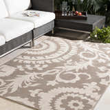 Outdoor patio scene with light beige Collegeport Area Rug, wicker furniture, and neutral tones. Roomscene-Rectangle