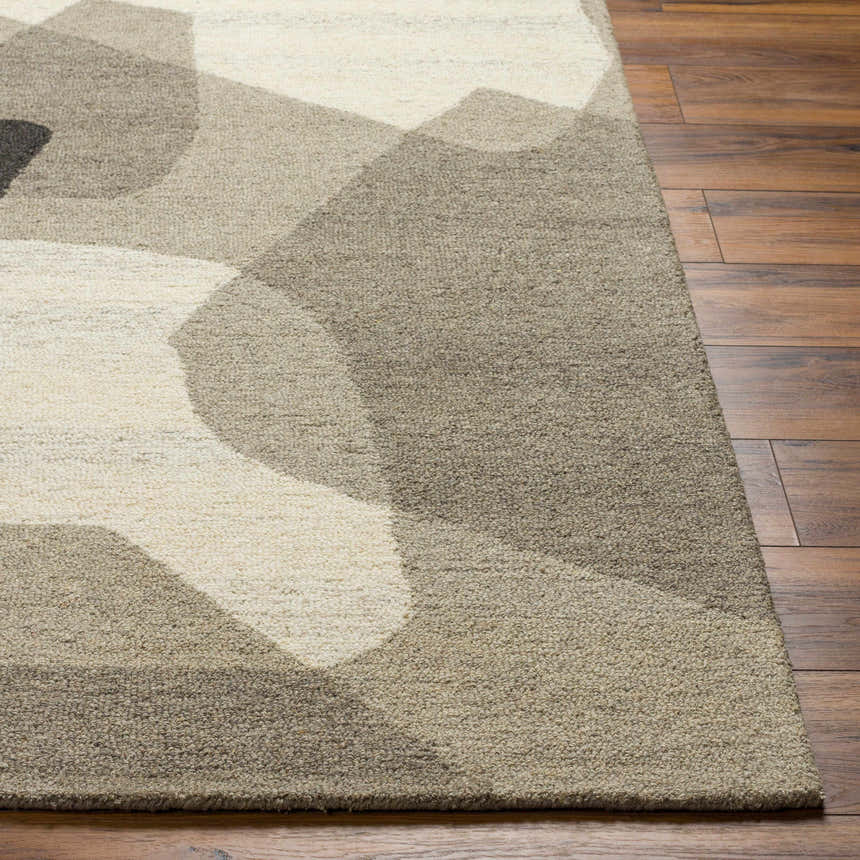 Close-up of the hand-tufted Colin Area Rug. Beige, bone, and gray geometric design on a textured wool rug. Front