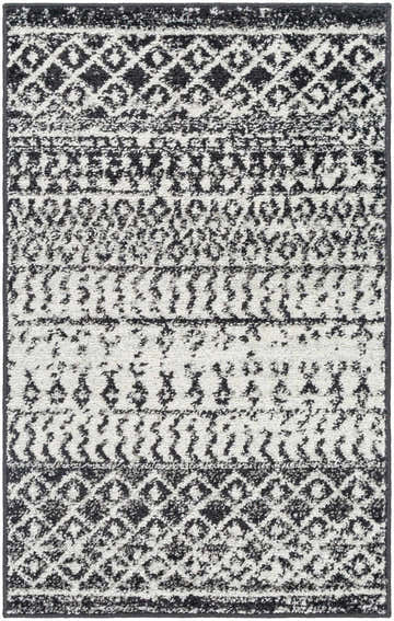Close-up of the Constantin Area Rug, showcasing its black, gray, and white bohemian-inspired geometric pattern. Design-Rectangle-23