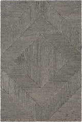 Close-up of the Conshohocken Area Rug. Black and cream wool rug with a bold, geometric, concentric diamond pattern. Design-Rectangle-576