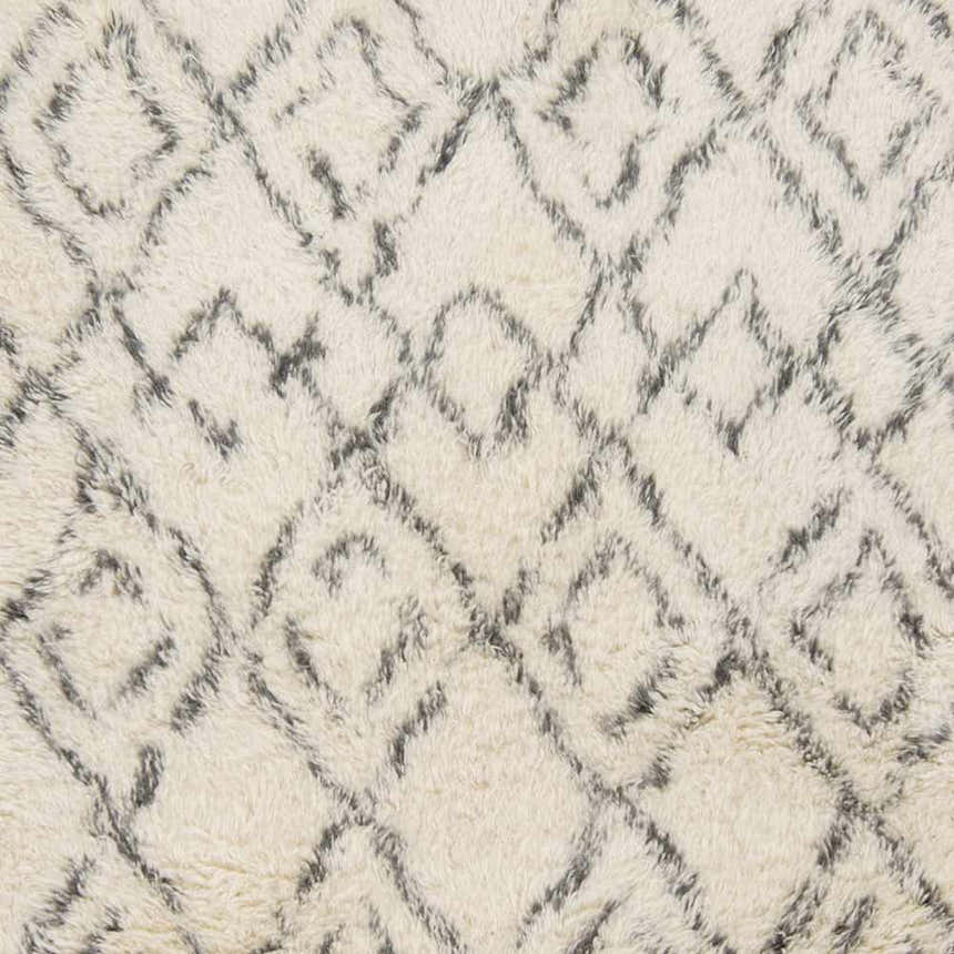 Close-up of the Cotgrave 2x3 cream trellis wool rug. Hand-woven shag texture with a geometric diamond pattern. Swatch