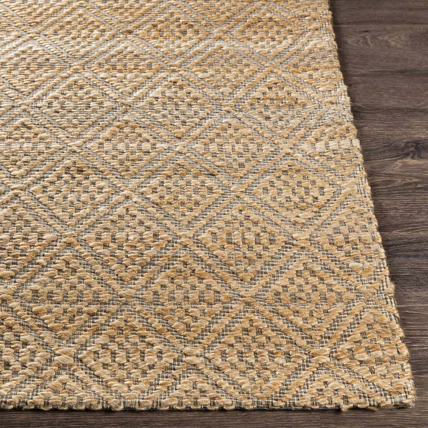 Close-up of the textured Buwoi Hand Woven Tan Jute Rug showing the diamond pattern and natural jute fibers on a wood floor. Front