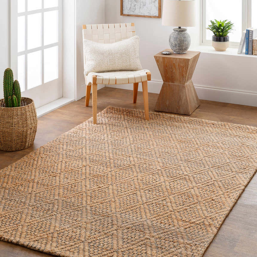 Light and airy room scene with Buwoi Hand Woven Tan Jute Rug, woven chair, and natural wood accents. Roomscene-Rectangle