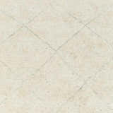 Close-up of the hand-knotted Caramoran Premium Rug. Beige wool and viscose blend with a subtle gray diamond pattern. Swatch