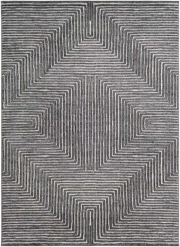 Close-up of the Carnarvon Area Rug, a machine-woven rug with a geometric black, cream, and gray pattern. Design-Rectangle-5373