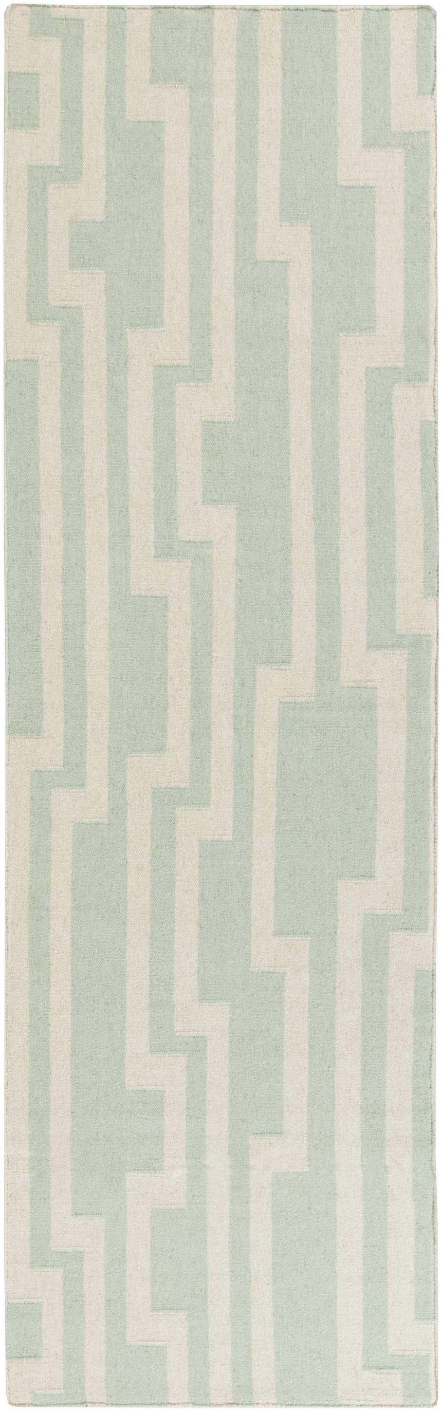 Close-up of the Carteret Area Rug, a hand-woven wool rug with an ice blue and light beige geometric pattern. Design-Runner-268