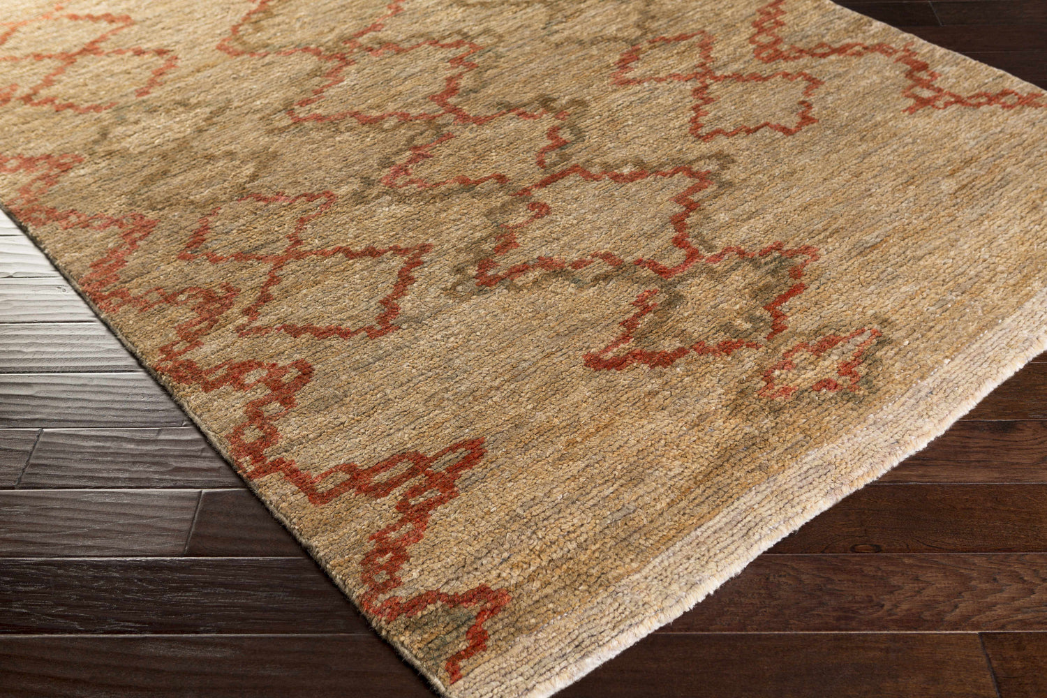 Close up of the beige Crowley Jute Carpet with red geometric pattern on dark hardwood floors. Farmhouse style. Corner