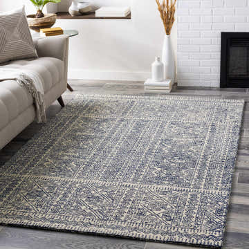 Living room scene with a Cottenham Area Rug. The rug is wool with a blue and cream bohemian pattern. Roomscene-Rectangle