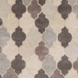 Close-up of the Cuero Area Rug; hand-knotted wool rug in charcoal, light brown, and taupe with a quatrefoil pattern. Swatch