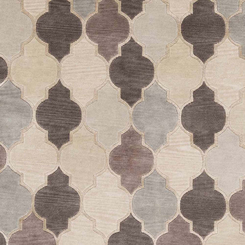 Close-up of the Cuero Area Rug; hand-knotted wool rug in charcoal, light brown, and taupe with a quatrefoil pattern. Swatch