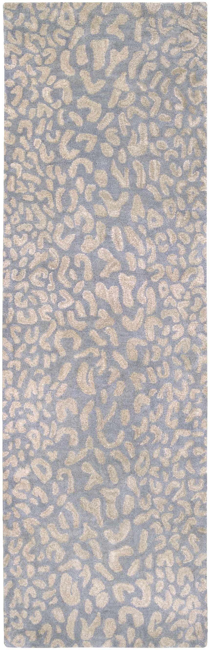 Close-up of the Curwensville Leopard Print Area Rug. Slate blue background with a taupe animal pattern. Hand-tufted wool rug. Design-Runner-268
