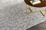 Close-up of the hand-loomed Cushendall Premium Rug. Dark blue and off-white contemporary rug with a textured design. Styleshot