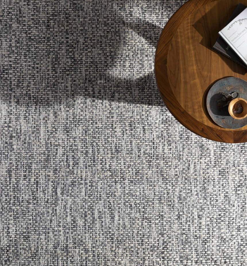 Close-up of the hand-loomed Cushendall Premium Rug. Dark blue and off-white contemporary design with a subtle woven texture. Styleshot