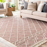 Living room scene with a Dacudao Area Rug. Burgundy rug with a cream geometric pattern under a beige sofa. Roomscene-Rectangle