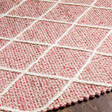 Close up of the Dacudao Area Rug showing the cream geometric pattern on a burgundy and dusty pink wool weave. Texture