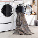 Dagatan Washable Area Rug in laundry room being pulled from dryer. Beige, black, and camel oriental rug. Washing-Machine