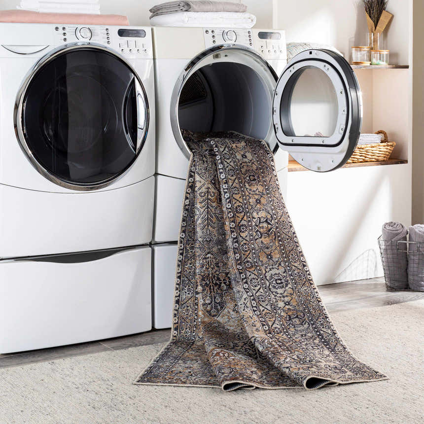 Dagatan Washable Area Rug in laundry room being pulled from dryer. Beige, black, and camel oriental rug. Washing-Machine