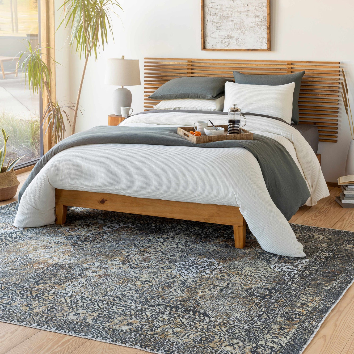 Bedroom scene with a beige, black, and gray Dagatan Washable Area Rug under a wood bed frame. Roomscene-Rectangle