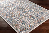 Close-up of the Dagny Area Rug showing a traditional floral pattern in cloud gray, light gray, multi brown, and taupe. Corner