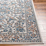 Close-up of the Dagny Area Rug showing the traditional floral pattern in cloud gray, light gray, multi brown, nutmeg, and taupe. Front
