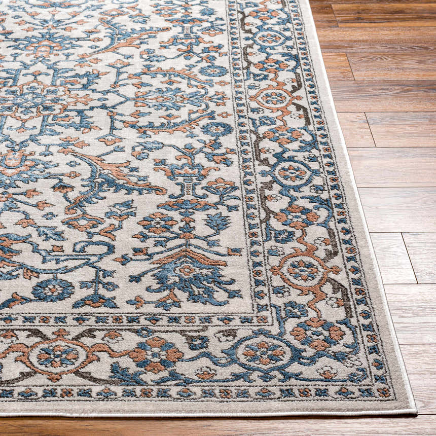 Close-up of the Dagny Area Rug showing the traditional floral pattern in cloud gray, light gray, multi brown, nutmeg, and taupe. Front
