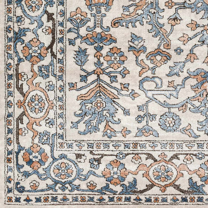 Close-up of the Dagny Area Rug. Farmhouse style with cloud gray, light gray, blue, and nutmeg floral pattern. Swatch