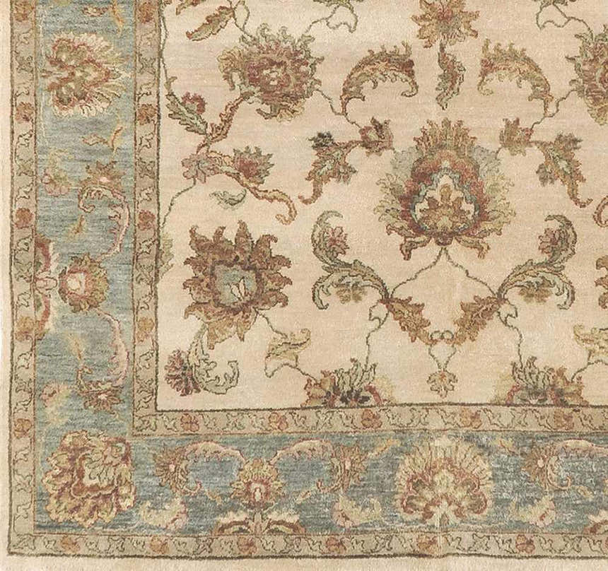 Close-up of the Dahlonega Area Carpet showing its beige field, brown and burgundy floral pattern, and dusty sage border. Swatch