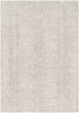 Close-up of the Daiva Luxe Rug, showcasing a beige and gray dotted pattern and soft, textured weave. Design-Rectangle-537