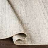 Close-up of the Dalaoig Flat Woven Wool Rug in cream and charcoal, showing the texture and hand-woven construction. Fold