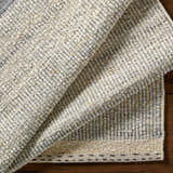Close-up of the textured Dalaoig Flat Woven Wool Rug. Features cream, charcoal, and beige tones with a hand-woven design. Fold
