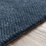 Close up of the hand knotted Dateland Area Rug in navy and pale blue. Wool and viscose blend. Texture