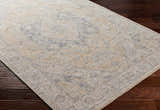 Close-up of the Deena Thick Luxe Area Rug in brown, charcoal, and sage on dark wood floors. Farmhouse style. Corner
