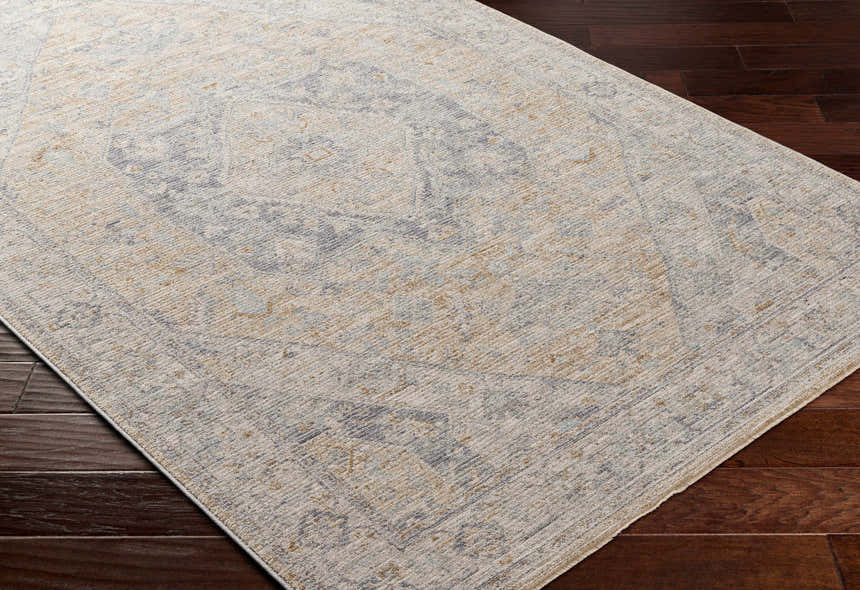 Close-up of the Deena Thick Luxe Area Rug in brown, charcoal, and sage on dark wood floors. Farmhouse style. Corner