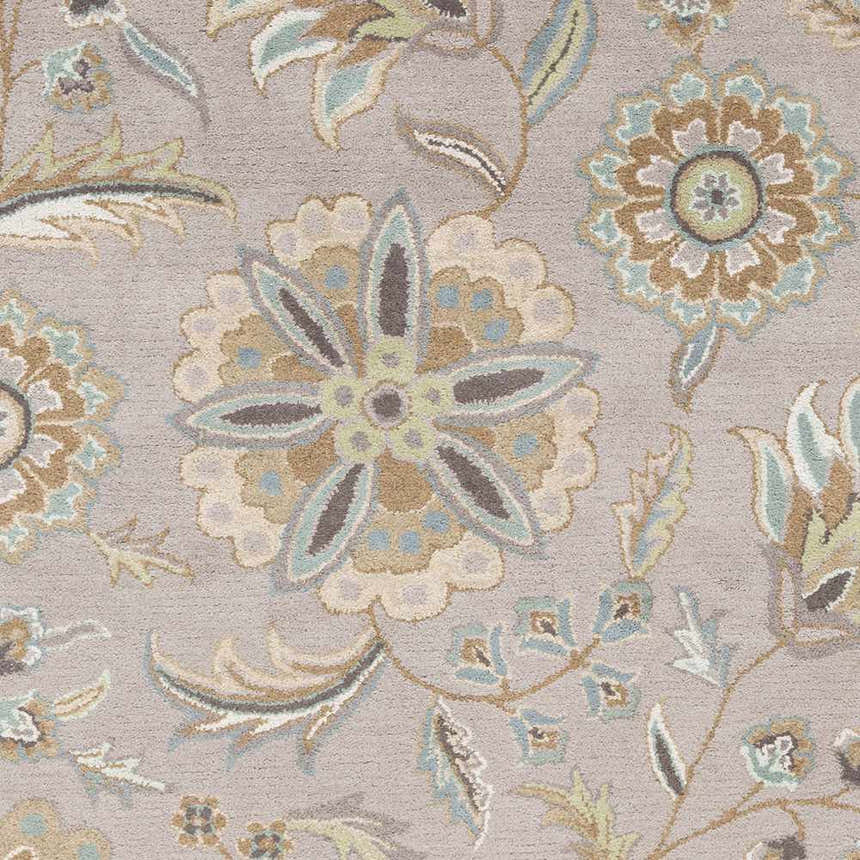 Close-up of the Denio Area Rug. Hand-tufted wool rug with a traditional floral pattern in brown, sage, and sky blue on a taupe background. Swatch