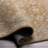 Close-up of the Dimboola Wool & Faux Silk Rug, showcasing its traditional pattern, wool texture, and colors of gold, orange, and gray. Fold