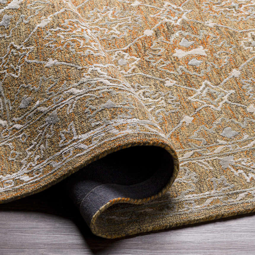 Close-up of the Dimboola Wool & Faux Silk Rug, showcasing its traditional pattern, wool texture, and colors of gold, orange, and gray. Fold