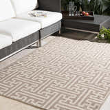 Patio scene with a beige Divernon Area Rug, white sofa, and dark wicker table. Roomscene-Rectangle