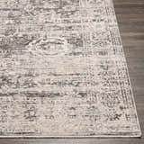 Close-up of the Divisoria Area Rug, a traditional design in charcoal, cream, and gray on a dark wood floor. Front