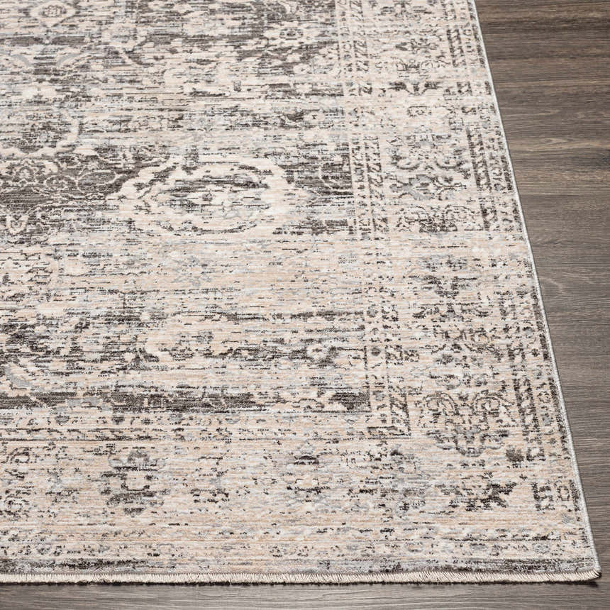 Close-up of the Divisoria Area Rug, a traditional design in charcoal, cream, and gray on a dark wood floor. Front