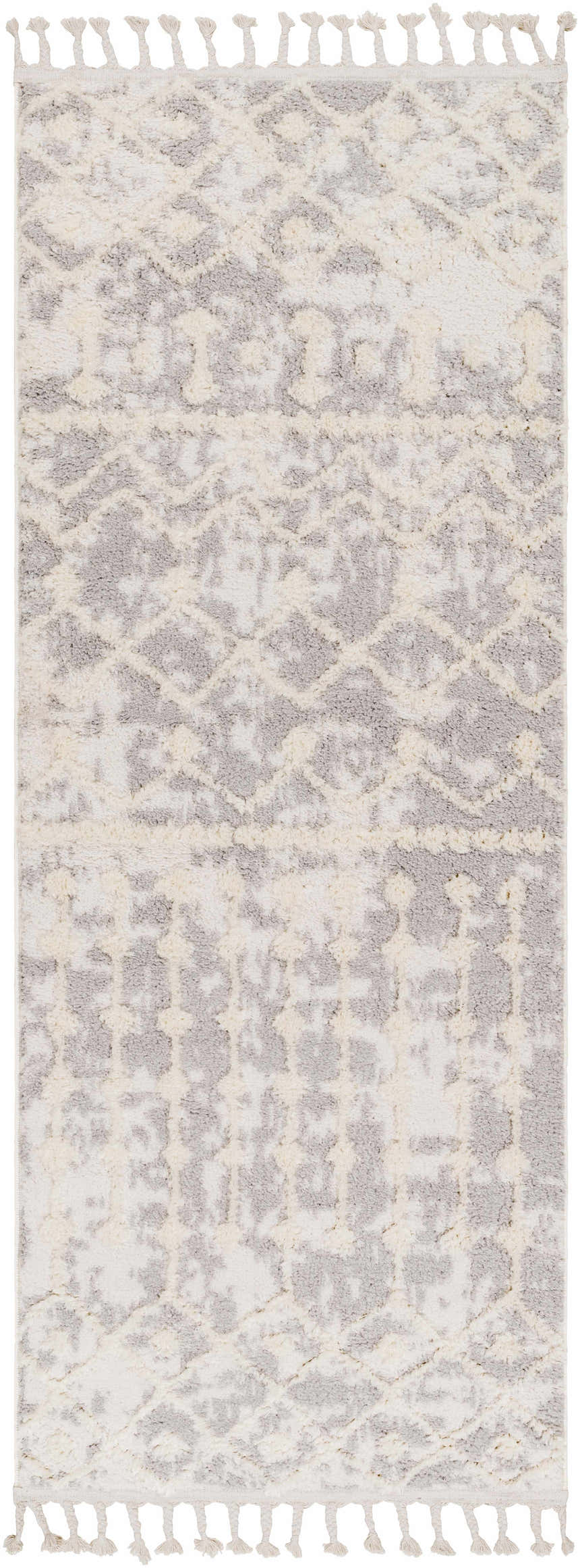 Close-up of the Dolo Area Rug. Cream and gray polyester rug with a geometric pattern and tassels. Bohemian style. Design-Runner-2773